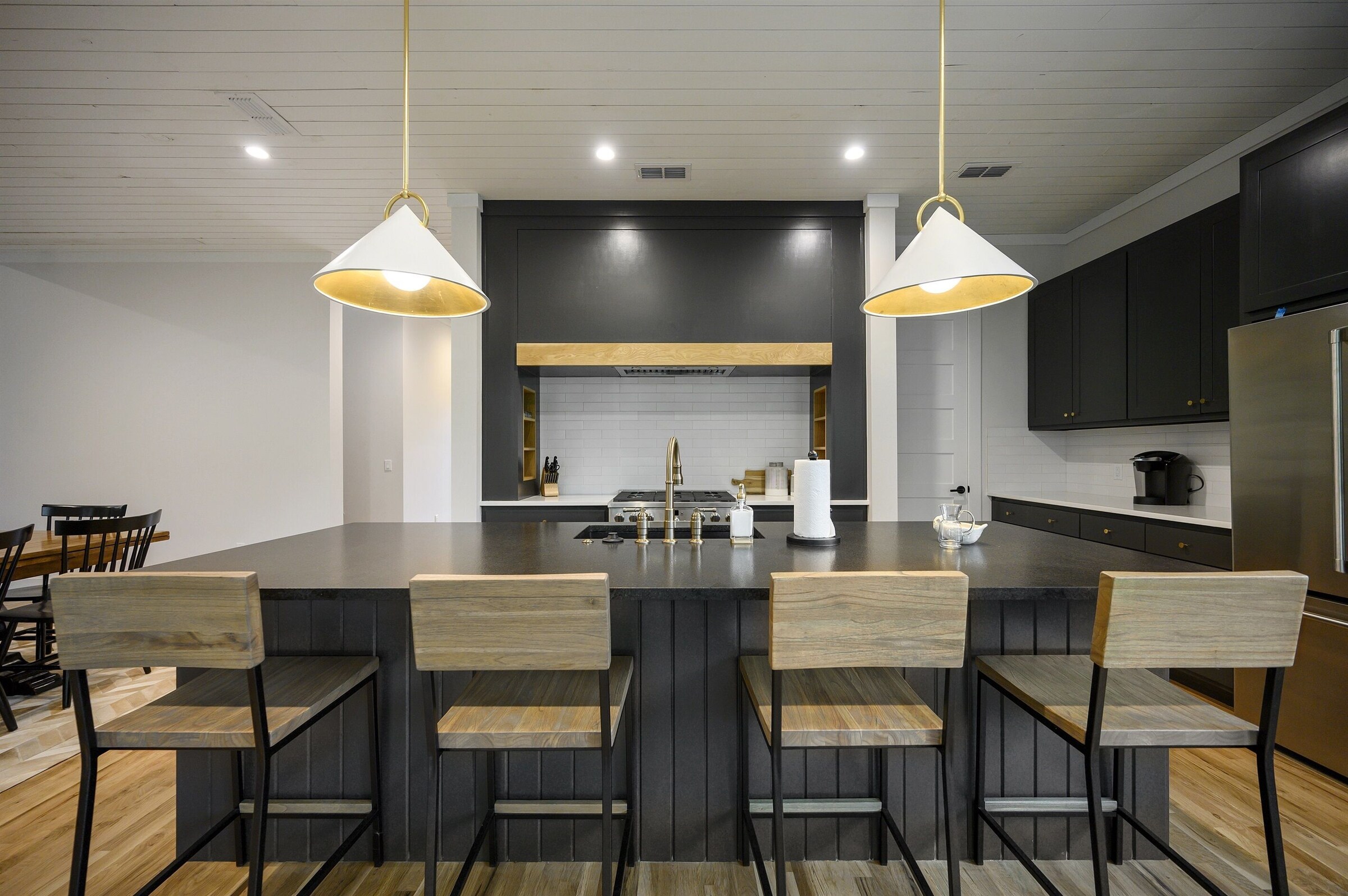 Kitchen island with bar stools and pendant lights