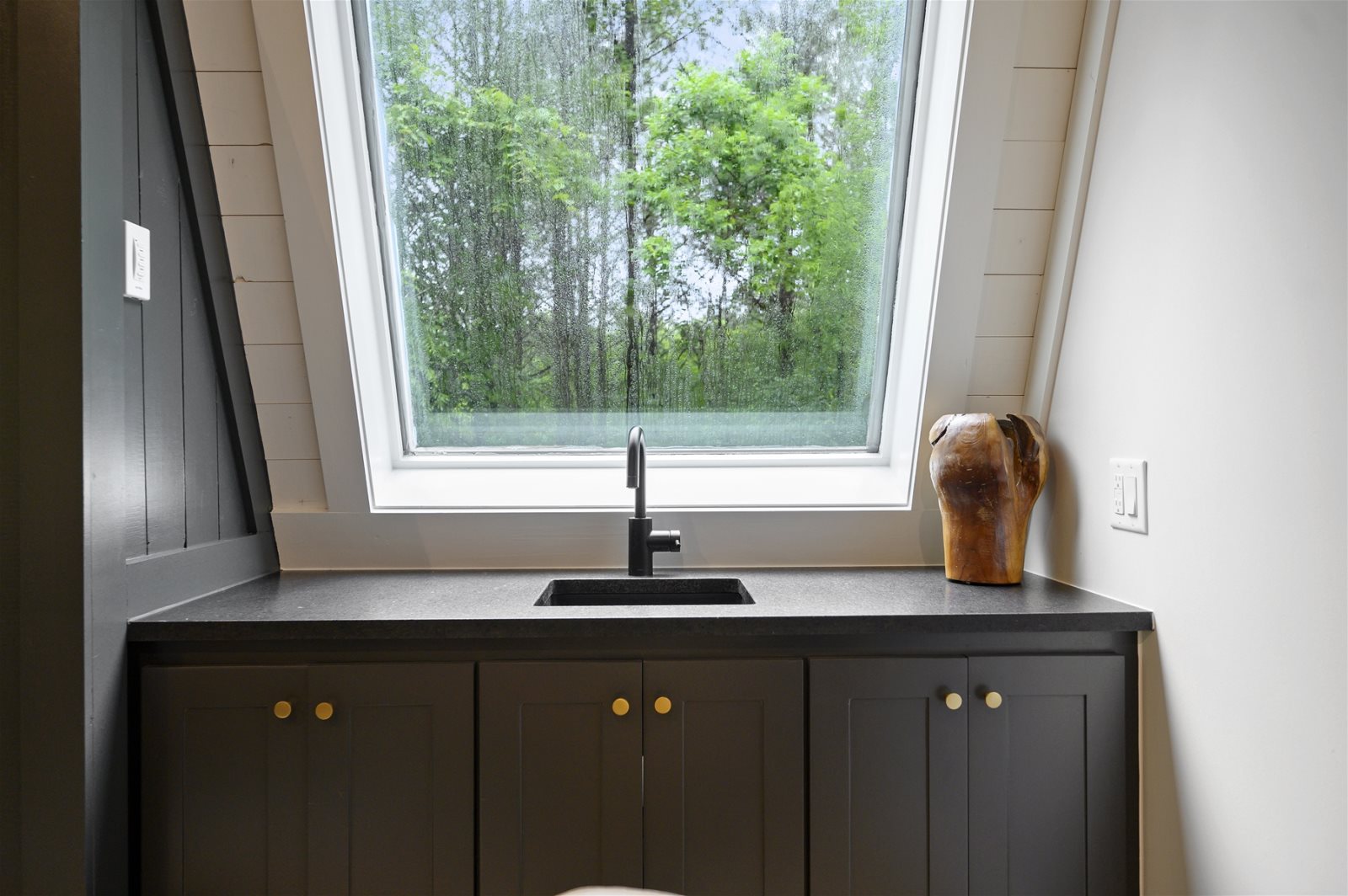 Wet bar with a window to the trees